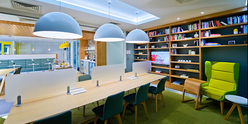 A Regus building with a desk and chair in a library
